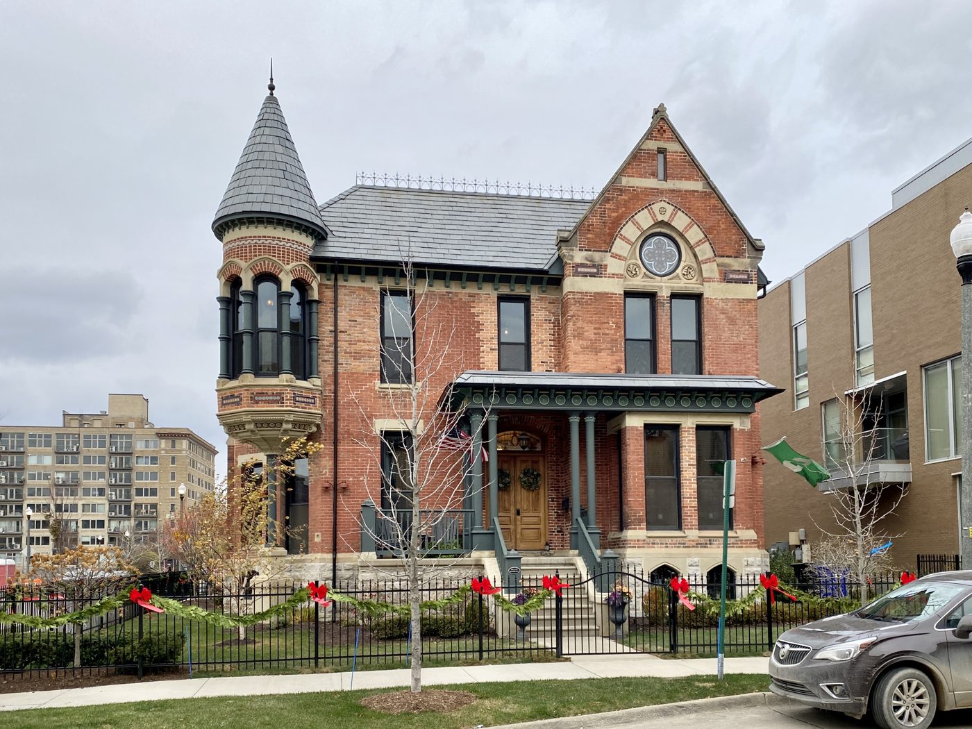 A restored Victorian house beside modern infill apartments in Brush Park, Detroit
